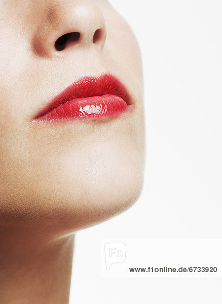 Studio shot of young woman wearing red lipstick mouth