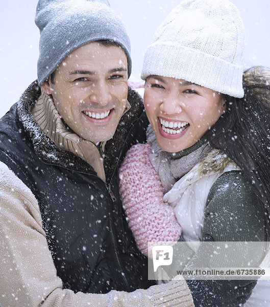 Couple wearing warm clothing smiling