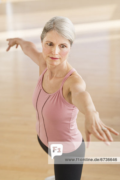 Portrait of senior woman exercising in gym