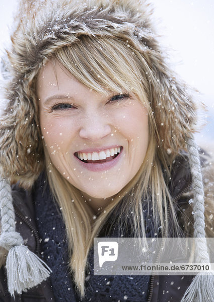 Portrait of woman wearing knit hat laughing