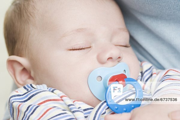 Close up of sleeping baby with pacifier