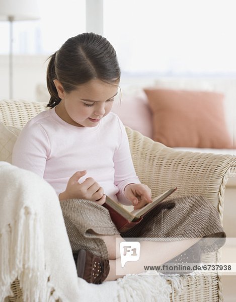 Girl reading in chair