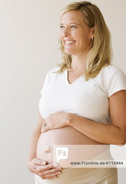 Pregnant woman with hands on belly