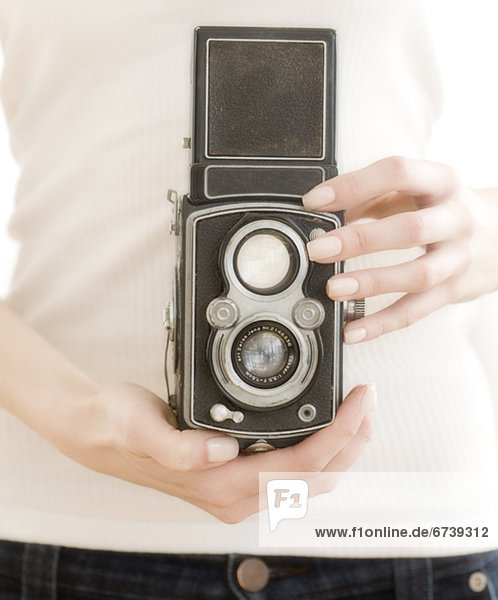 Woman holding old fashioned camera