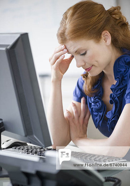 Frustrated businesswoman sitting at her desk