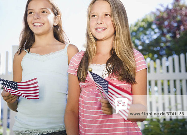 USA  New York  Two girls (10-11  10-11) playing with American flags