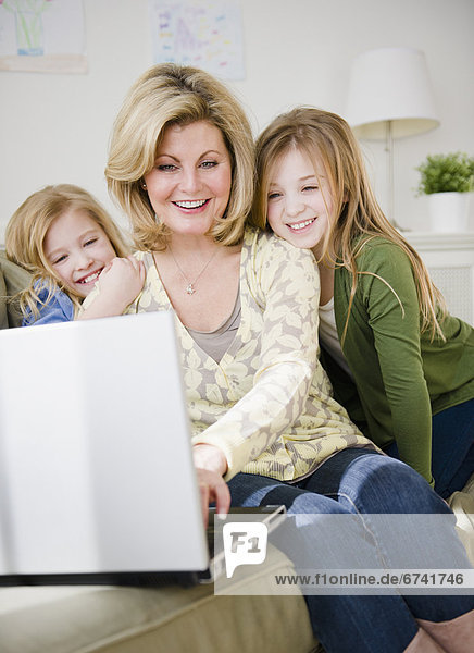 USA  Jersey City  New Jersey  mother and daughters (8-11) using laptop