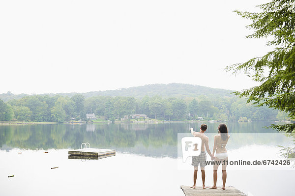 USA  New York  Putnam Valley  Roaring Brook Lake  Couple standing on pier by lake