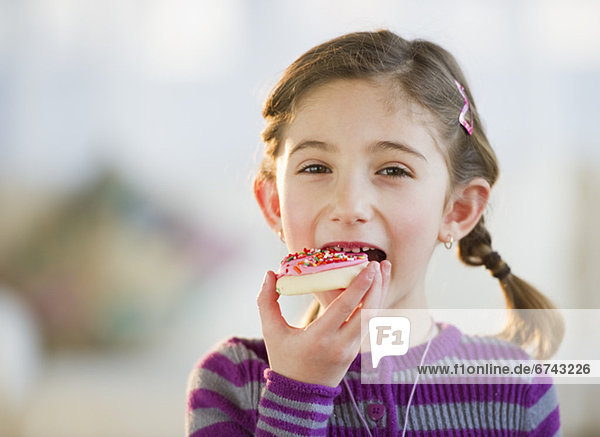 Young girl eating a cookie