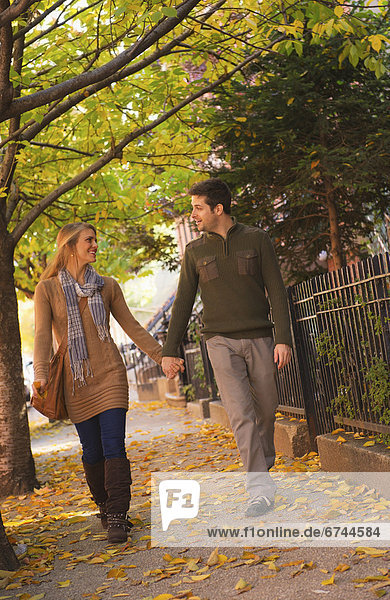 Young couple walking on pavement