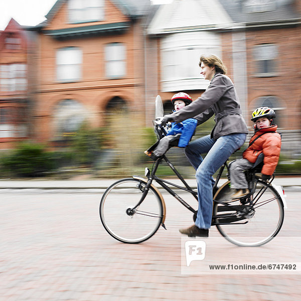 Woman on Bicycle with two kids  Cabbagetown  Toronto  ON