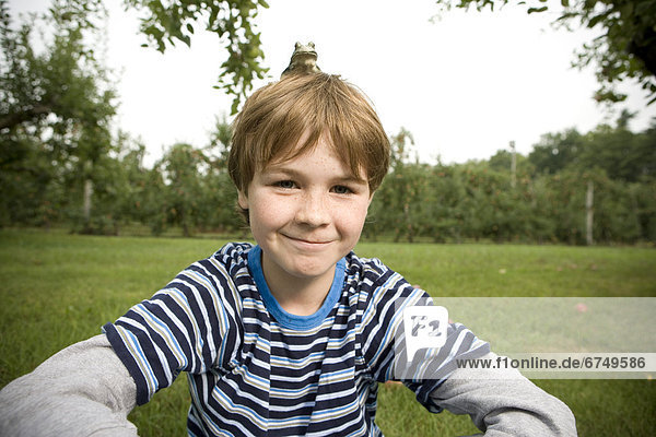 Boy Sitting with Frog on his Head