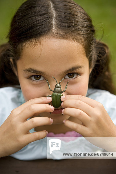 Close-up of Girl with Insect on her Face