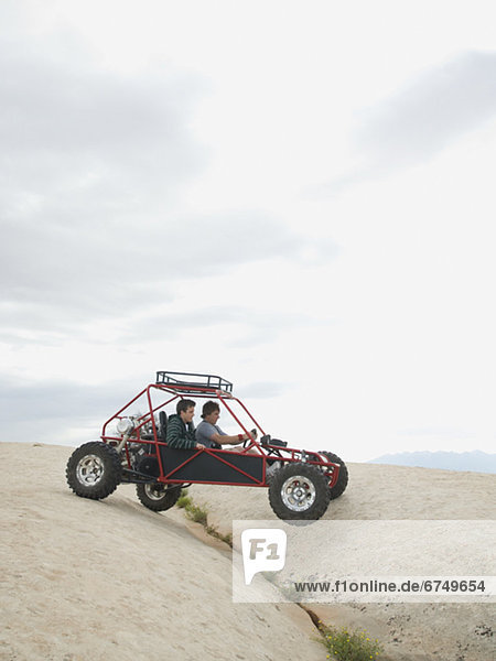People in off-road vehicle on rock formation