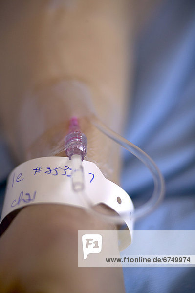 Woman s Hand with Hospital Wristband and Intravenous Needle