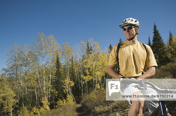 Man sitting on mountain bike  Utah  United States