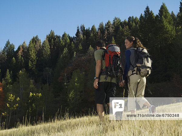 Couple hiking with backpacks  Utah  United States
