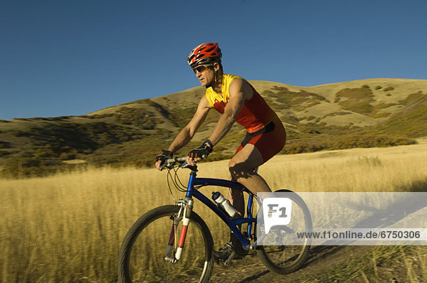 Man riding mountain bike  Salt Flats  Utah  United States