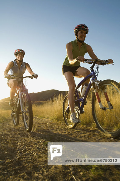Two women riding mountain bikes  Salt Flats  Utah  United States