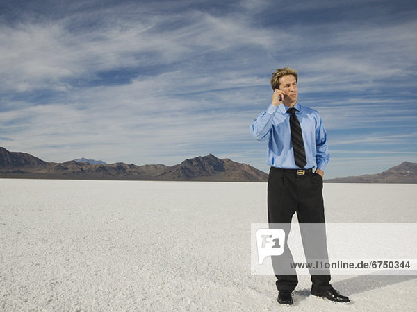 Businessman talking on cell phone  Salt Flats  Utah  United States