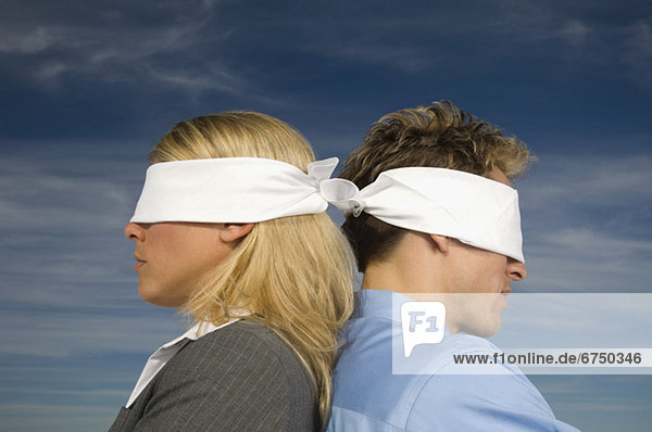 Blindfolded businesspeople standing back to back  Salt Flats  Utah  United States