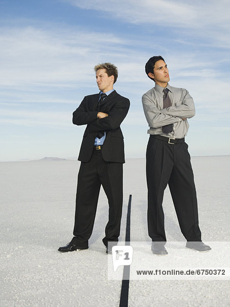 Businessmen on opposite sides of line  Salt Flats  Utah  United States