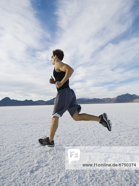 Man running on salt flats  Utah  United States