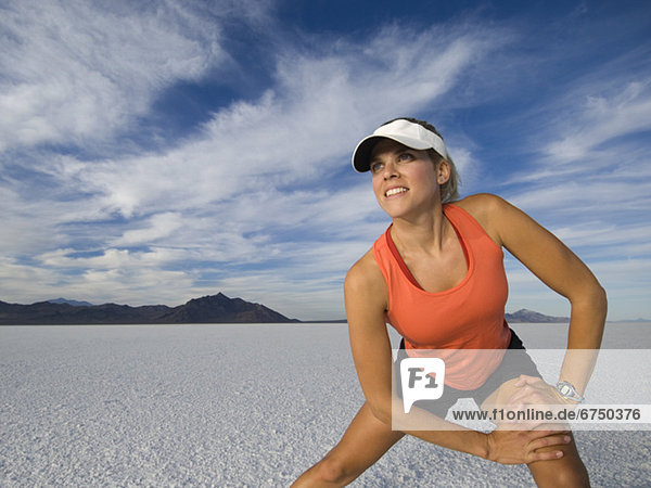 Woman stretching at salt flats  Utah  United States