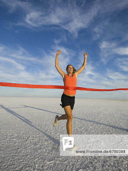 Woman running across finish line  Utah  United States