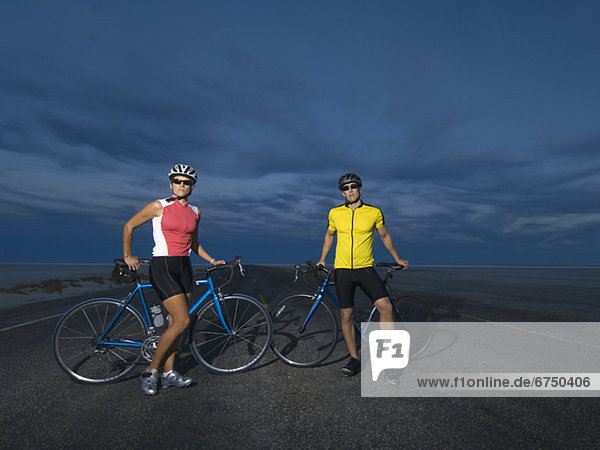 Couple with bicycles on road  Utah  United States