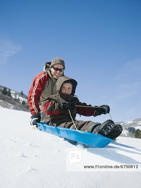 Father and son on sled