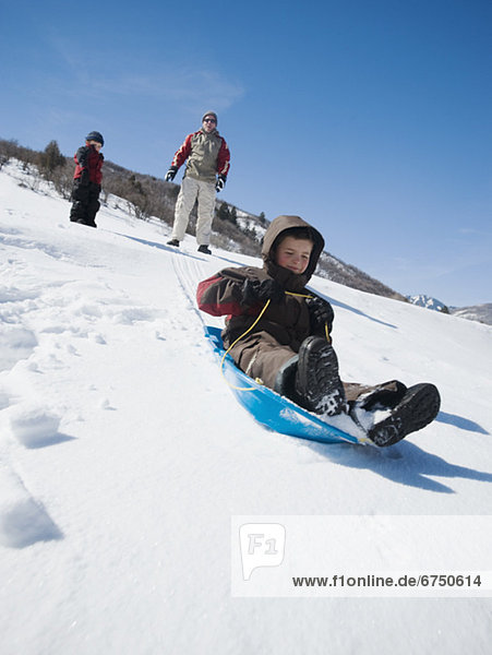 Boy riding on sled