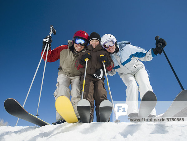 Family standing on skis