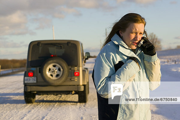 Woman with Disabled Vehicle on Cellphone