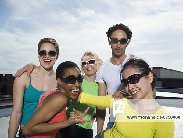 Multi-ethnic friends wearing sunglasses