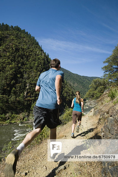 Runners on riverside trail