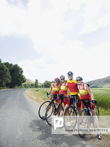 Cyclists posing on country road