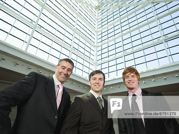 Businessmen posing in convention center atrium