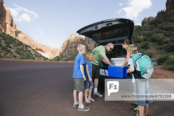 A family on vacation at Red Rock unloading a van