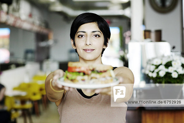 Waitress Holding Out Sandwich