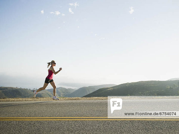 Runner training on the side of the road
