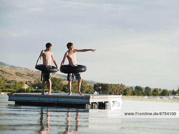 Boys (10-11 12-13) jumping from raft