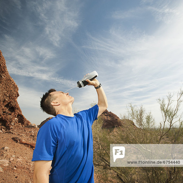 USA  Arizona  Phoenix  Man pouring water on his face