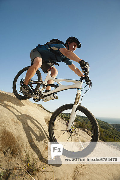 USA  California  Laguna Beach  Mountain biker riding downhill