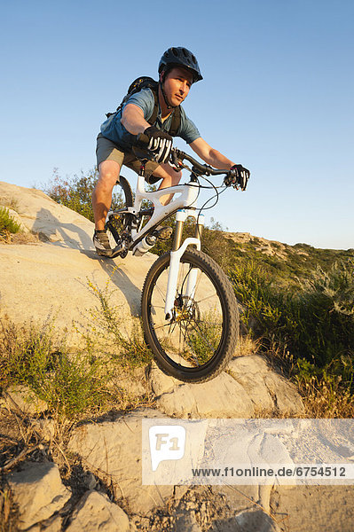 USA  California  Laguna Beach  Man cycling down hill