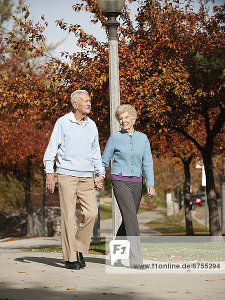 Senior couple strolling in park