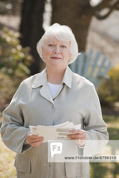 USA  Virginia  Richmond  portrait of senior woman holding bills