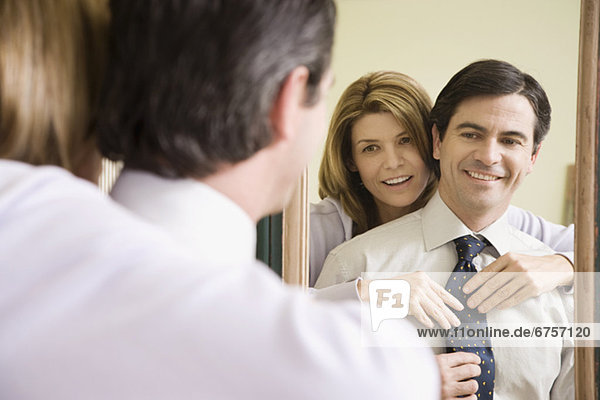 Woman adjusting husbandÕs necktie