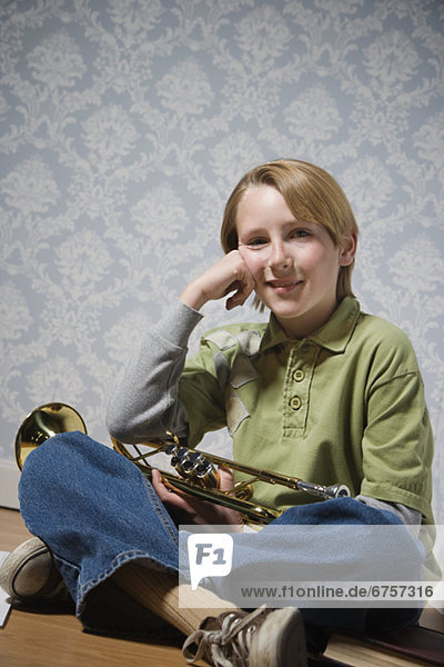 Boy holding trumpet