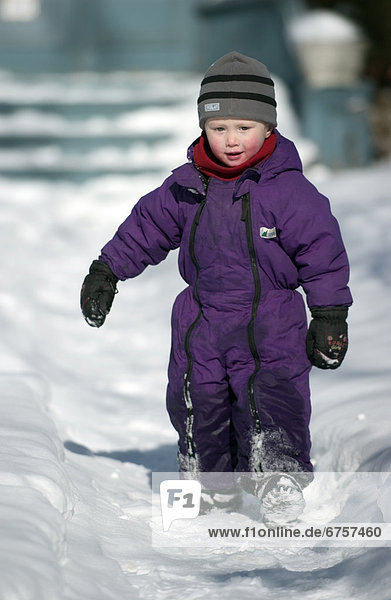 Boy Walking on Snow Covered Path